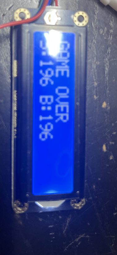 Close-up of the LCD showing GAME OVER and S:196 B:196.